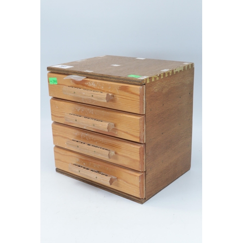 393 - A small wooden four drawer chest containing assorted watch parts