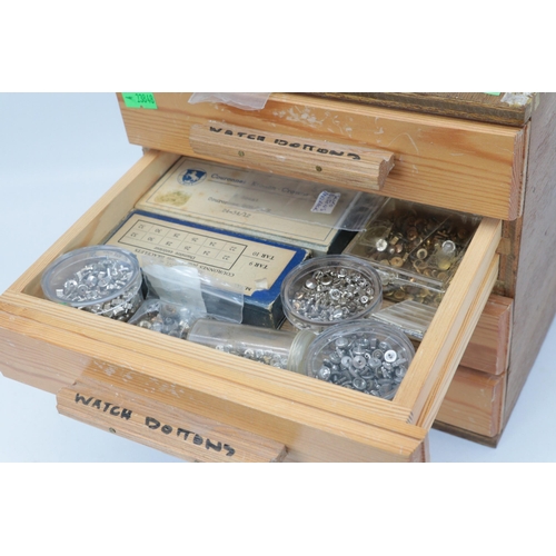 393 - A small wooden four drawer chest containing assorted watch parts