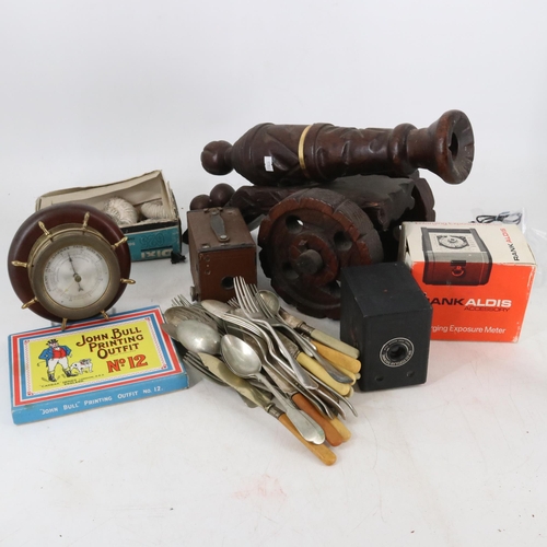 67 - A mixed clearance lot to include; a wooden cannon, cameras, fossils, barometer, cutlery, and large s... 