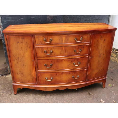 258 - Reproduction yew wood finish sideboard, bow fronted fitted four centre drawers and two cupboards mea... 