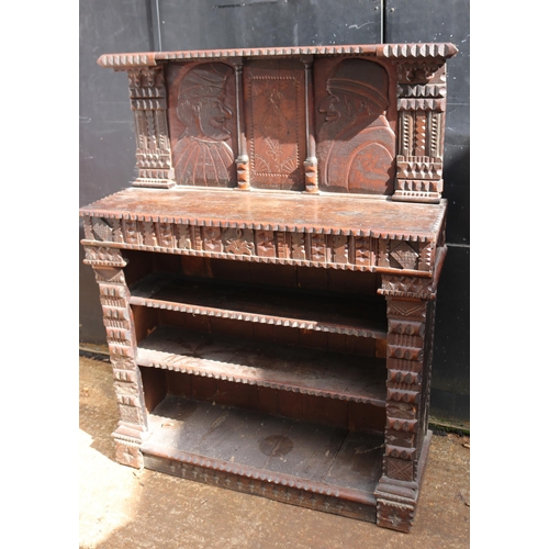 410 - Carved oak continental bookcase with raised back, decorated with Caricatures measuring approx 111cm ... 