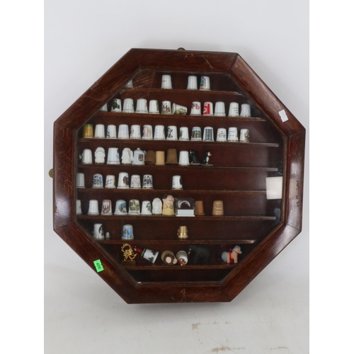 45 - Two octagonal glaze fronted display cases full of ceramic and porcelain thimbles