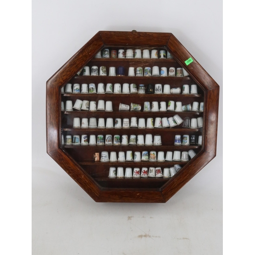 45 - Two octagonal glaze fronted display cases full of ceramic and porcelain thimbles