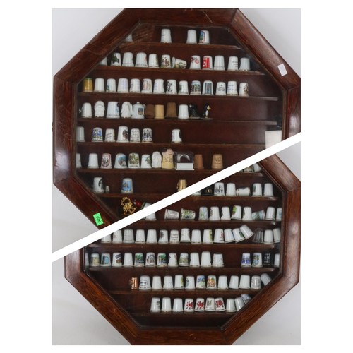 45 - Two octagonal glaze fronted display cases full of ceramic and porcelain thimbles