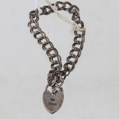 28 - A Sterling Silver hallmarked bracelet with heart-shaped lock.