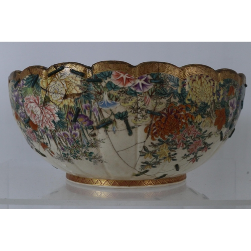 41 - Japanese bowl heavily decorated with chrysanthemums etc, restored with staples measures approx 10inc... 