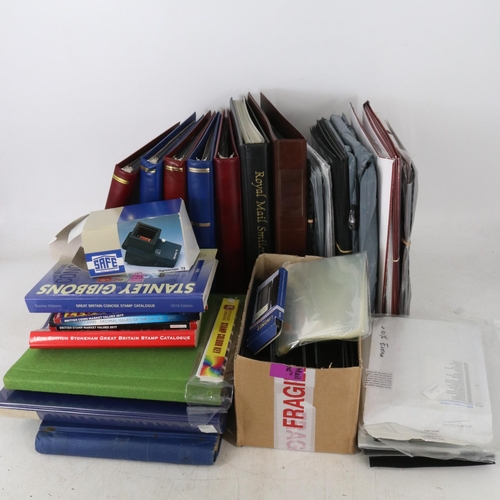 56 - Three boxes of mainly empty Royal Mail stamp albums and first day cover albums and many more loose a... 