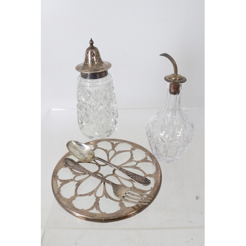 23 - Small quantity of silver to include a silver and glass trivet, a monogrammed spoon and fork, cut gla... 