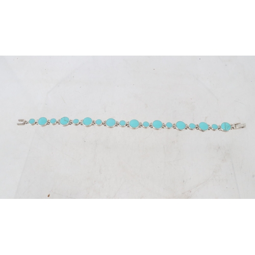 32J - A silver and turquoise bracelet.