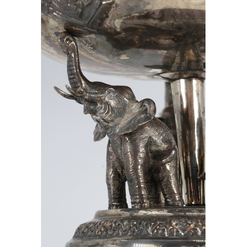 3 - An unusual eastern white metal flower table centrepiece supported on three elephants and fitted to a... 