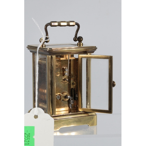 9 - Miniature brass cased carriage clock with key. approx. 10cm tall including upright handle