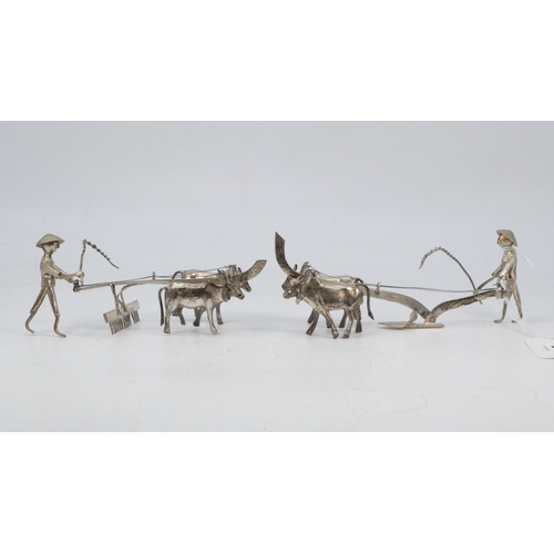 54 - Two Eastern white metal men ploughing. Size approx. 13cm long each