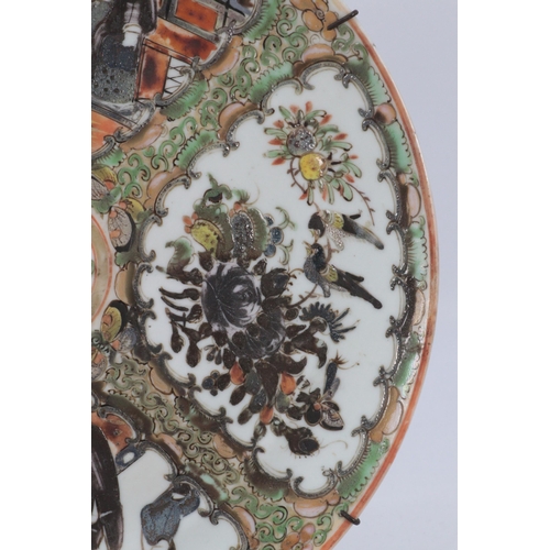 106 - A Chinese famille Rose plate decorated four panels and centre circle depicting scenes of people and ... 