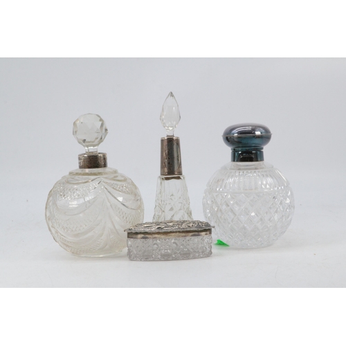 254 - Silver topped perfume bottle together with two silver collared similar and a silver topped trinket p... 