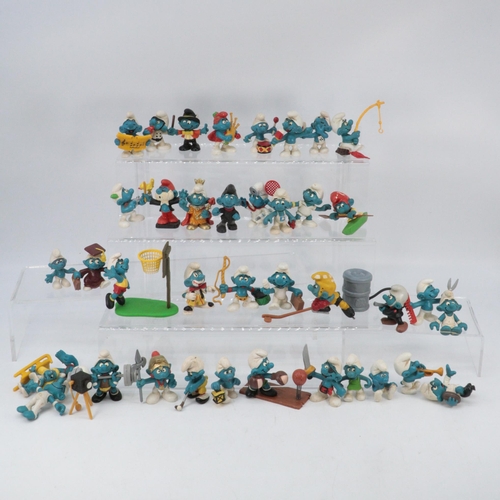 380 - A large quantity of vintage Smurfs Peyo including a boxed Smurf house