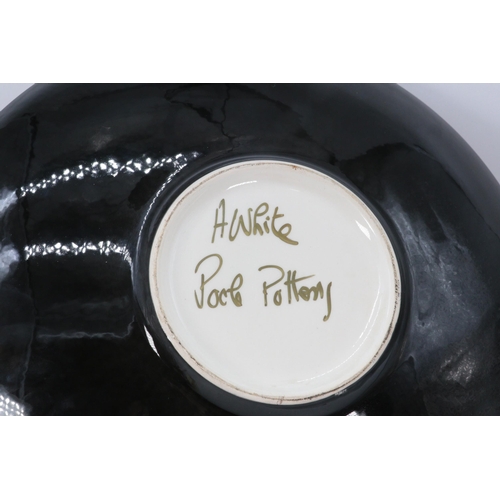 563 - A Poole Pottery charger measures approx. 40cm diameter signed to reverse Alan White