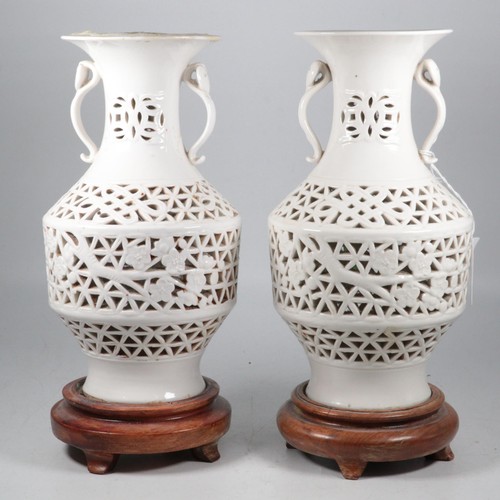 484 - A pair of oriental blanc de chine vases (glue residue to one as had been converted to lamps) togethe... 