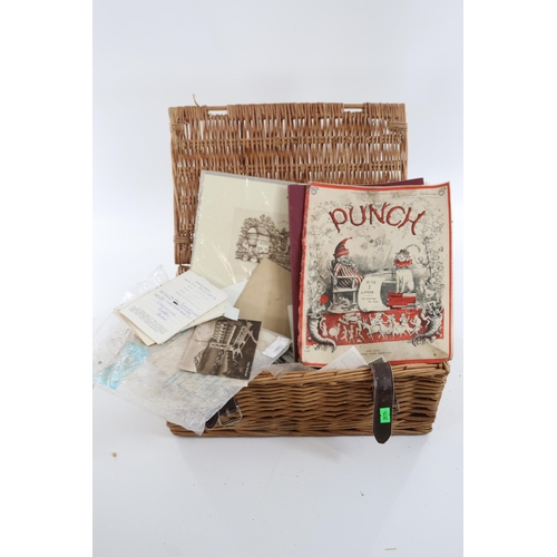 274 - A coin album with assorted coins and a selection of postcards together with a wicker basket of assor... 