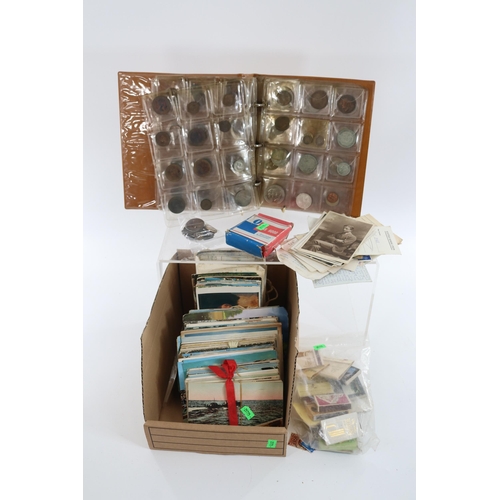 274 - A coin album with assorted coins and a selection of postcards together with a wicker basket of assor... 