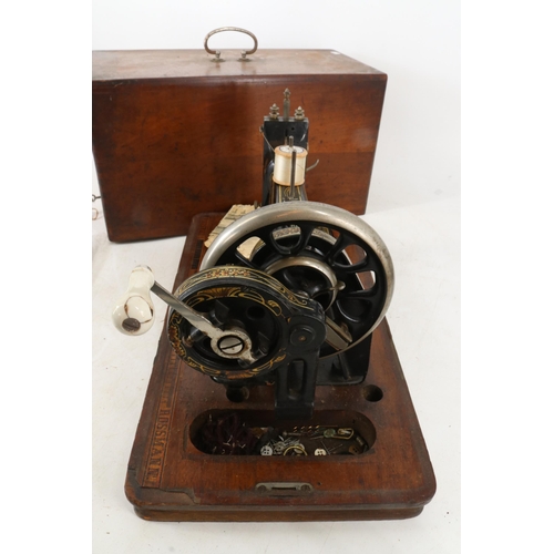 278 - Antique Frister & Rossmann sewing machine with instructions and case, highly decorated to the body a... 