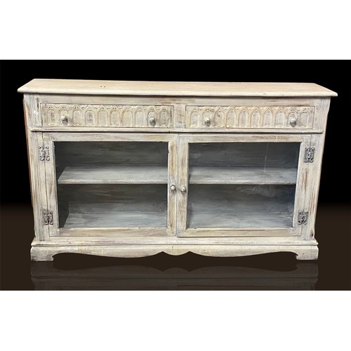 236 - A distressed painted two door oak bookcase fitted drawers above (measures approx. W135cm x D28cm x H... 