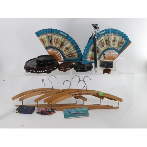 285 - Six vintage BOAC wooden hangers, two BOAC souvenir fans, wooden stands and a small tripod