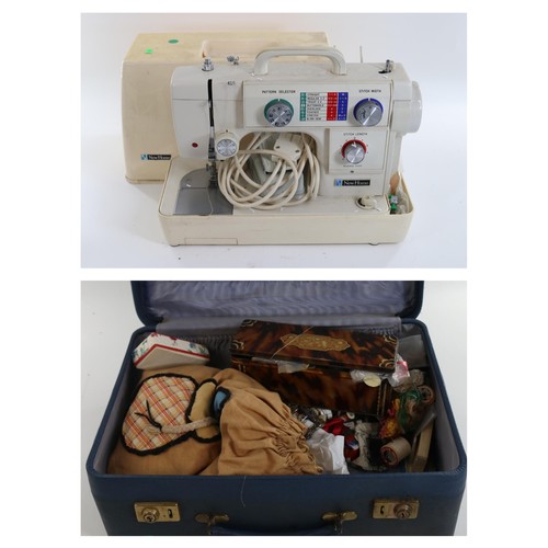 137 - A vintage New Home sewing machine together with a suitcase of sewing accessories, threads etc  (trad... 