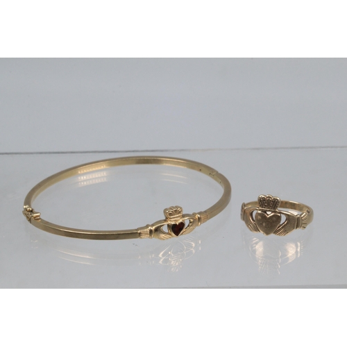 55 - A 9ct gold claddagh ring together with a similar unmarked yellow metal hinged bangle (approx. total ... 