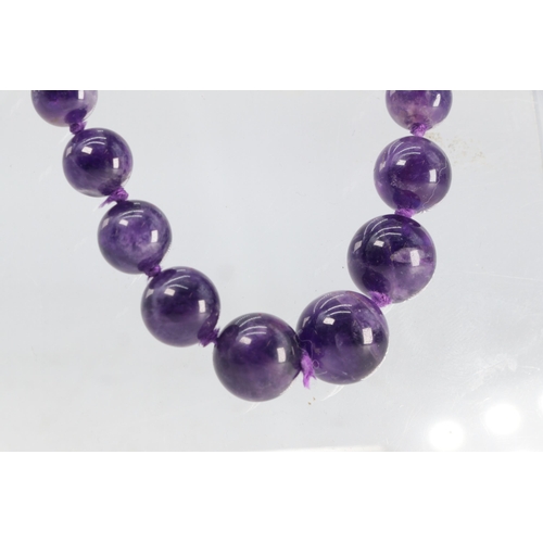 63 - A graduated Amethyst bead necklace with 9ct gold clasp