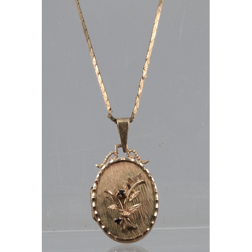 103 - A 9ct gold chain with 9ct gold locket with raised floral detail to front together with a 9ct gold ca... 