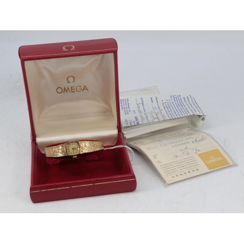 129 - Omega 9ct gold ladies watch and strap with papers and original box