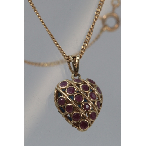 113 - A 9ct gold necklace with heart pendant set with sapphires and garnets