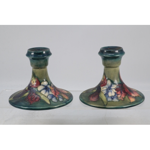 270 - A pair of Moorcroft decorative floral candlesticks (approx. 11cm tall)