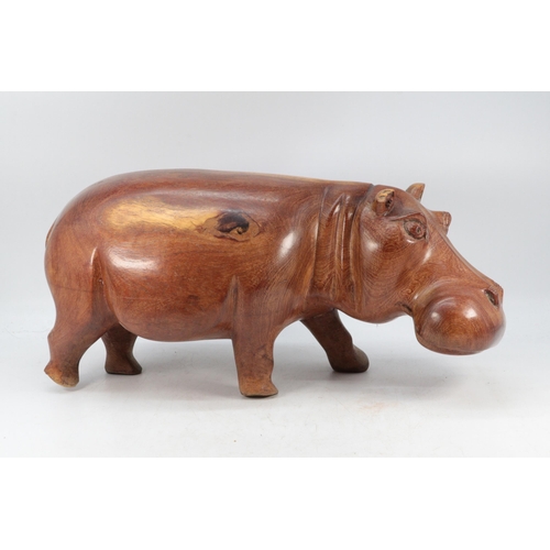 352 - A large wooden carved hippo (noted damage to ear) (approx. 46cm long x 24cm tall)