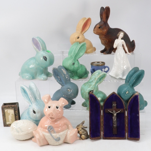 433 - A quantity of ceramic rabbits including some Sylvac, Wade pig moneybank, cased crucifix etc