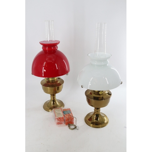 377 - Two unused oil lamps.