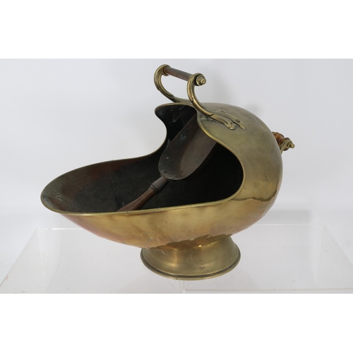 222 - A brass helmet coat scuttle and shovel