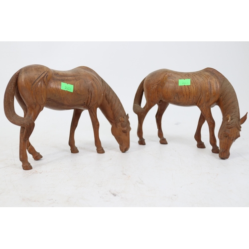 488 - Two wooden tang style horses, showing some damage to the ears