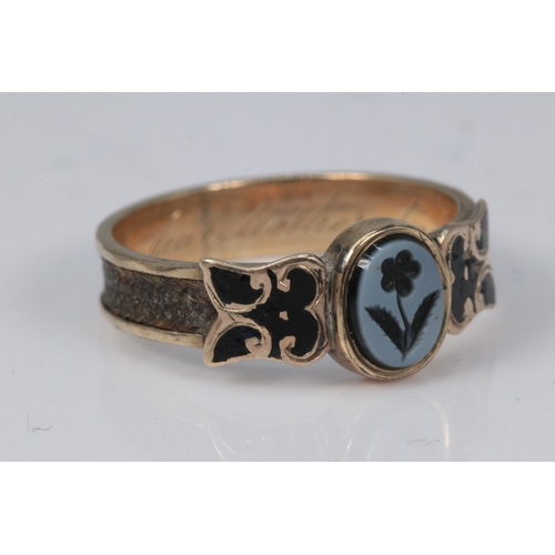 178 - Antique mourning ring set on unmarked gold, carved floral central stone, enamelled shoulders in memo... 