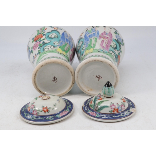 46 - Pair of Chinese famille rose vases with covers, Both showing damage to both covers.