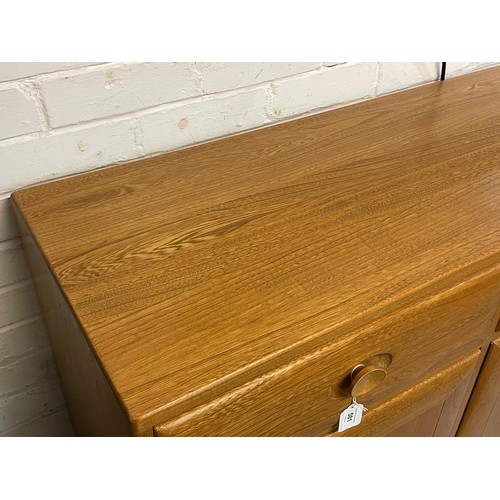 501 - An contemporary Ercol sideboard three drawers over three door cupboard base on plinth approx. approx... 