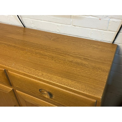 501 - An contemporary Ercol sideboard three drawers over three door cupboard base on plinth approx. approx... 