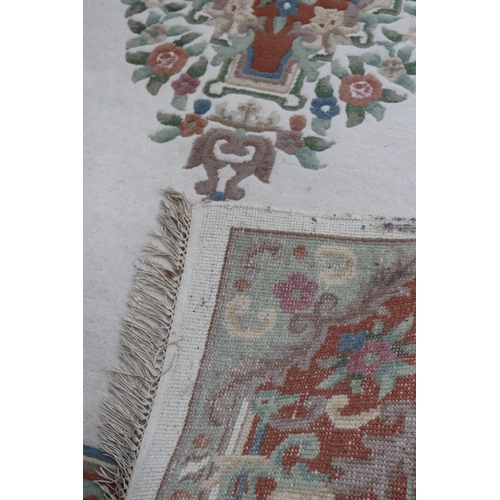 241 - Large oriental style rug with a cream ground measures approx. 273cm x 185cm