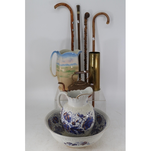 294 - Mixed lot consisting of four walking sticks, one decorated with souvenier badges, victorian jug and ... 