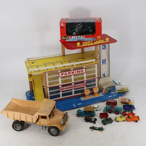 520 - 1960's toy garage with quantity of die cast and boxed Revell BMW Z1 together with a clock work truck