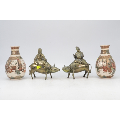 125 - Pair of Satsuma vases and a pair of Oriental brass figures riding Cows