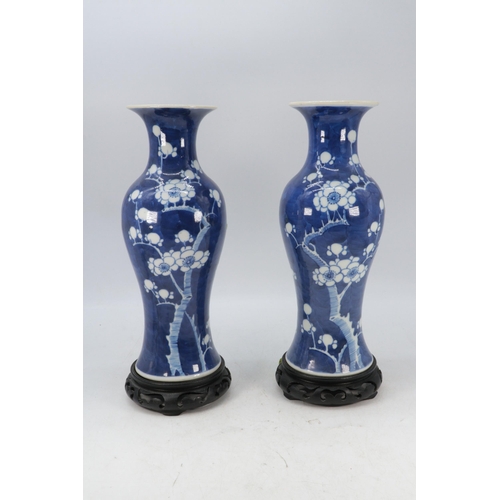 144 - A pair of Chinese ceramic prunus decorated vases with stands (approx. 30cm tall not including stand)