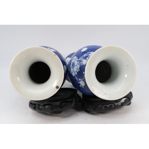 144 - A pair of Chinese ceramic prunus decorated vases with stands (approx. 30cm tall not including stand)