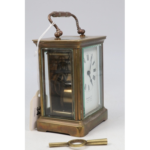 34 - Harrods brass carriage clock in travel case and key.