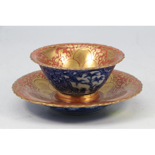 39 - Impressive Chinese tea bowl and matching saucer. Red ground with gilt borders and with Blue and whit... 